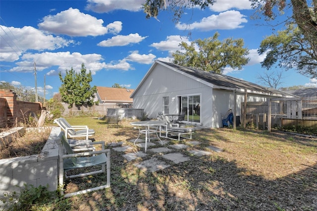 rear view of property with a lawn