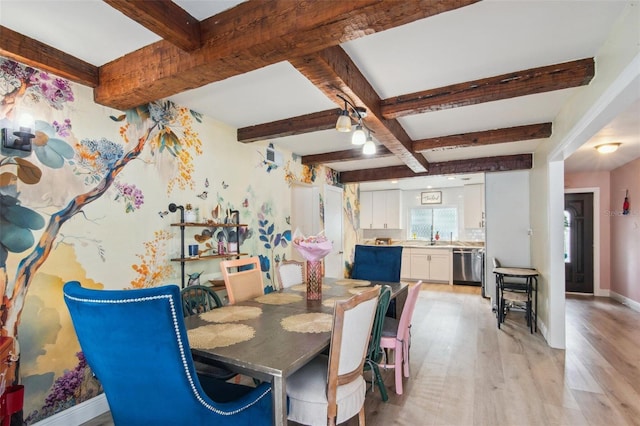 dining space with beam ceiling and light hardwood / wood-style floors