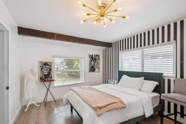 bedroom with a chandelier, hardwood / wood-style floors, multiple windows, and beam ceiling