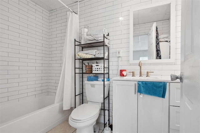 full bathroom featuring shower / tub combo, tile patterned floors, vanity, tile walls, and toilet