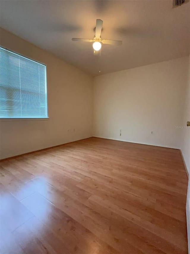 spare room featuring ceiling fan and light wood-type flooring