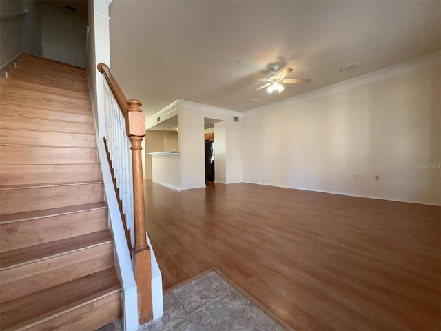 stairway featuring crown molding and ceiling fan