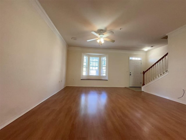 interior space with hardwood / wood-style floors, ceiling fan, and ornamental molding