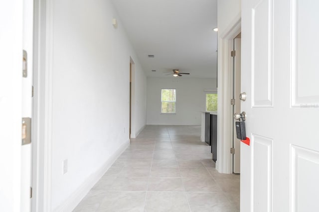 hallway featuring light tile patterned flooring