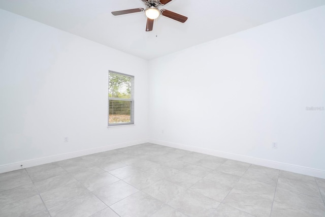 tiled empty room featuring ceiling fan