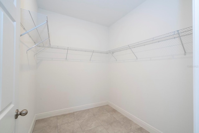 spacious closet featuring light tile patterned floors