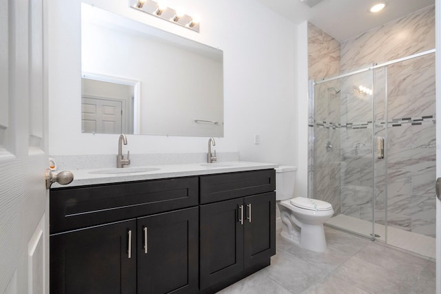 bathroom featuring vanity, toilet, and a shower with shower door