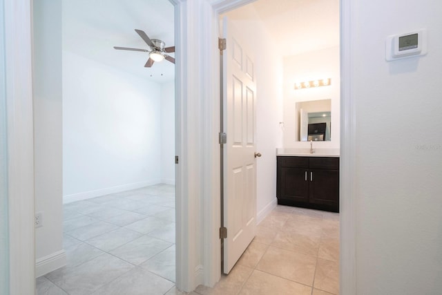 hall featuring light tile patterned floors