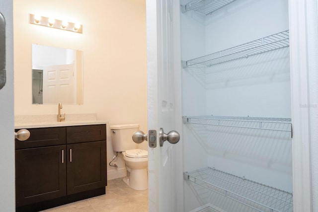 bathroom with tile patterned floors, vanity, and toilet