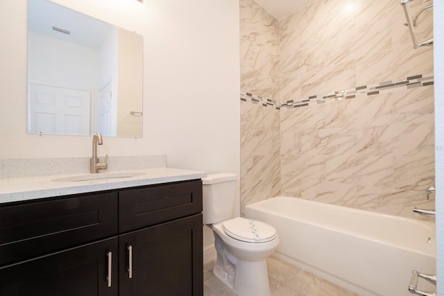 full bathroom with tile patterned flooring, vanity, tiled shower / bath combo, and toilet