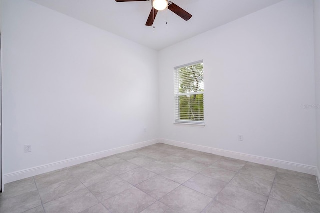 spare room with light tile patterned floors and ceiling fan