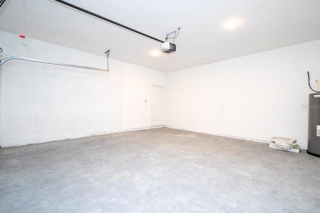 garage with electric water heater and a garage door opener