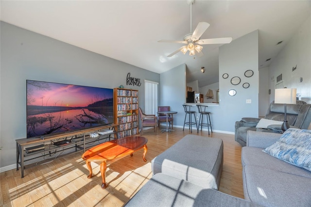 living room featuring hardwood / wood-style floors, ceiling fan, and high vaulted ceiling