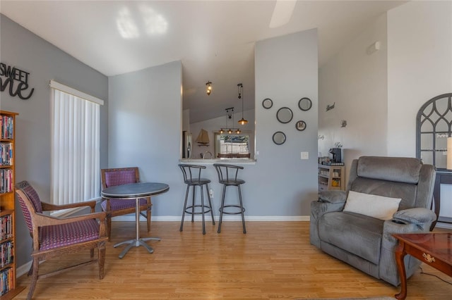 living area featuring light hardwood / wood-style floors and vaulted ceiling