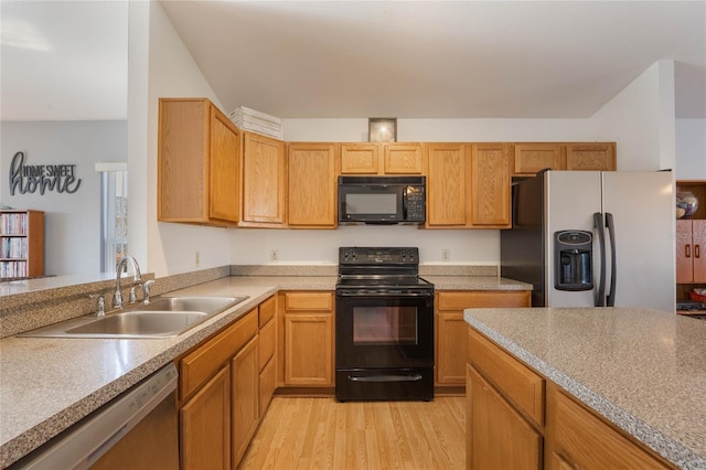 kitchen with sink, black appliances, and light wood-type flooring