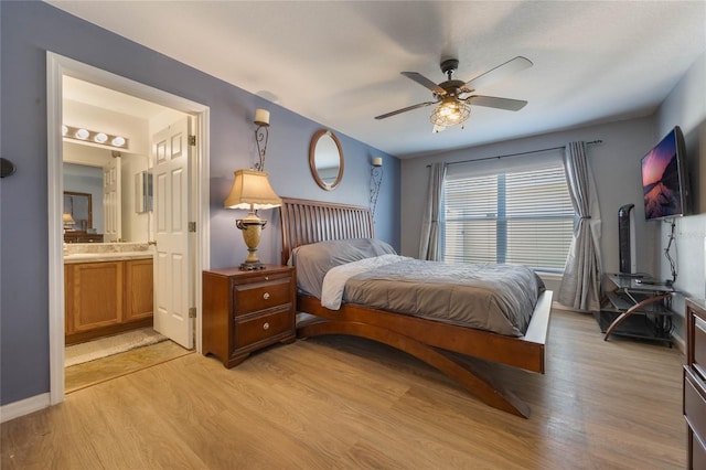 bedroom with ensuite bathroom, ceiling fan, and light wood-type flooring