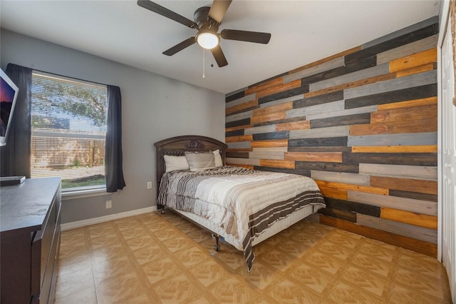 bedroom with wood walls and ceiling fan