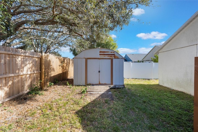 view of outdoor structure featuring a lawn