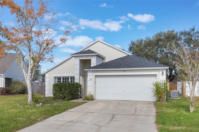 view of front of house with a front yard, central AC, and a garage