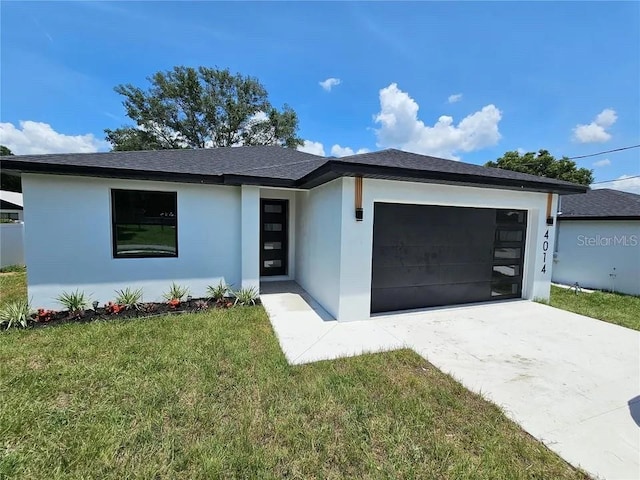 view of front facade featuring driveway, an attached garage, a front lawn, and stucco siding