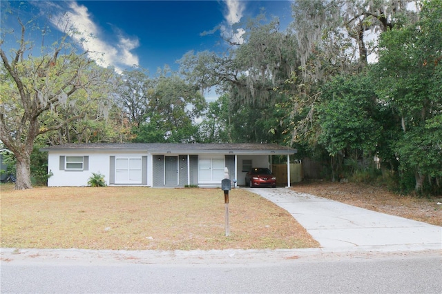 ranch-style house with a carport and a front lawn