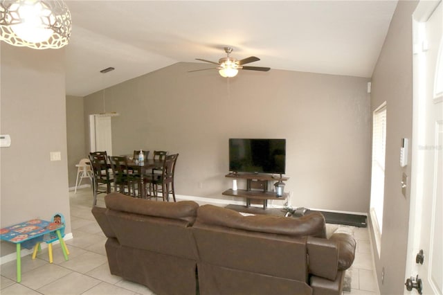 tiled living room featuring ceiling fan and lofted ceiling