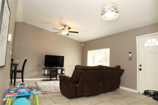 living room featuring ceiling fan, light tile patterned flooring, and lofted ceiling