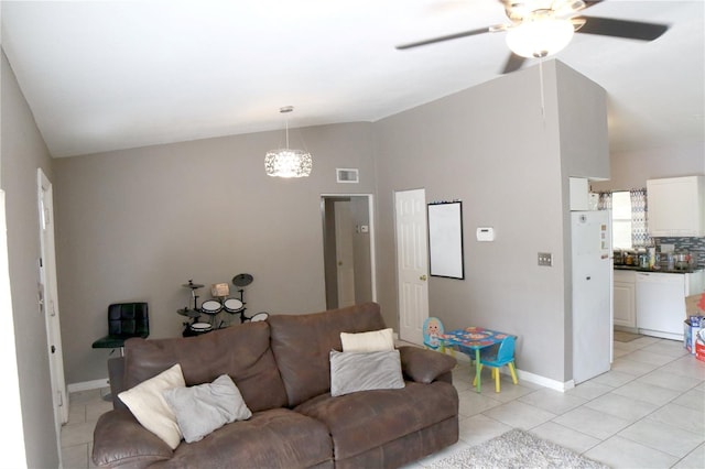 tiled living room with ceiling fan and vaulted ceiling