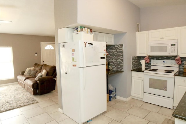 kitchen featuring decorative backsplash, light tile patterned floors, white appliances, and white cabinetry