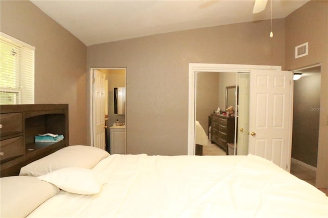 bedroom with ensuite bath, ceiling fan, and a closet