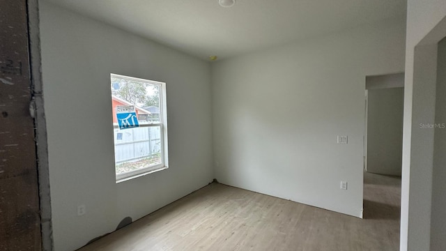 unfurnished room with light wood-type flooring