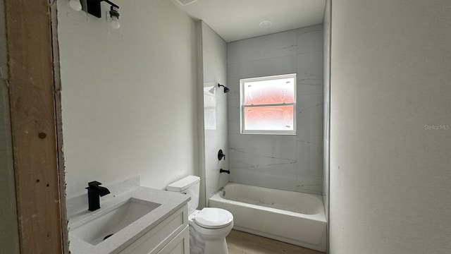 full bathroom with hardwood / wood-style floors, toilet, shower / washtub combination, and vanity