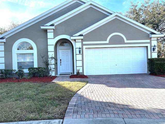 single story home featuring a front lawn and a garage