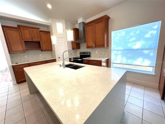 kitchen with decorative backsplash, sink, wall chimney range hood, hanging light fixtures, and stainless steel electric range