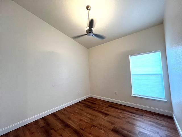 empty room with ceiling fan and dark hardwood / wood-style flooring