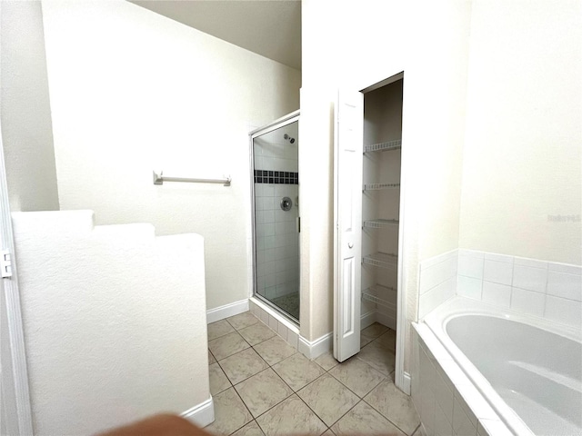 bathroom featuring separate shower and tub and tile patterned floors