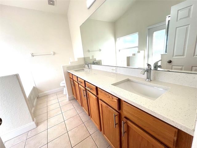 bathroom with tile patterned flooring, vanity, and toilet