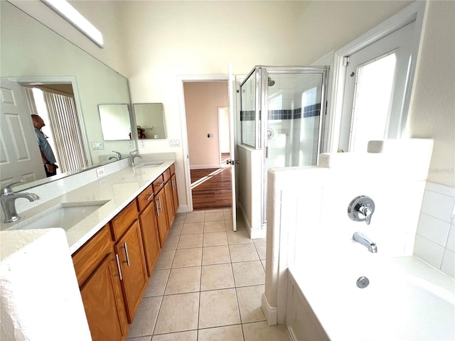 bathroom with tile patterned flooring, vanity, and separate shower and tub