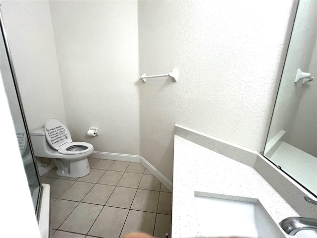 bathroom featuring tile patterned floors and toilet