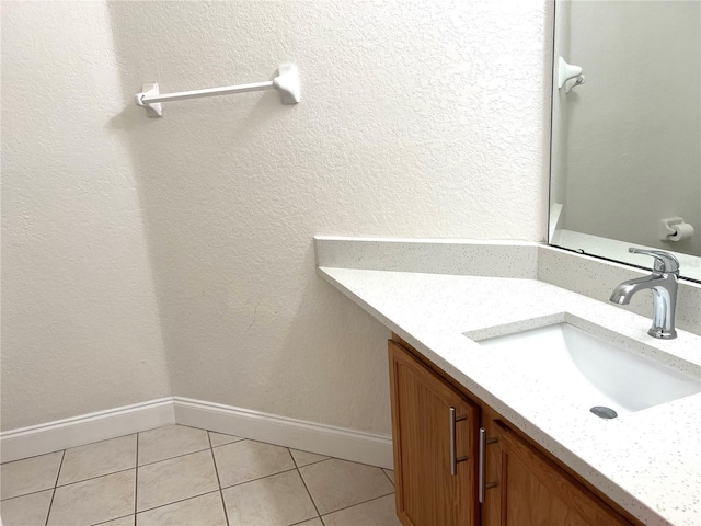 bathroom featuring tile patterned flooring and vanity