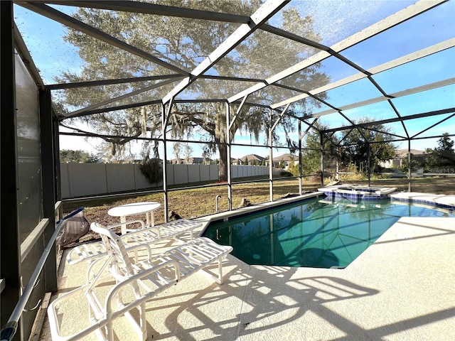 view of swimming pool featuring a lanai, a patio, and an in ground hot tub