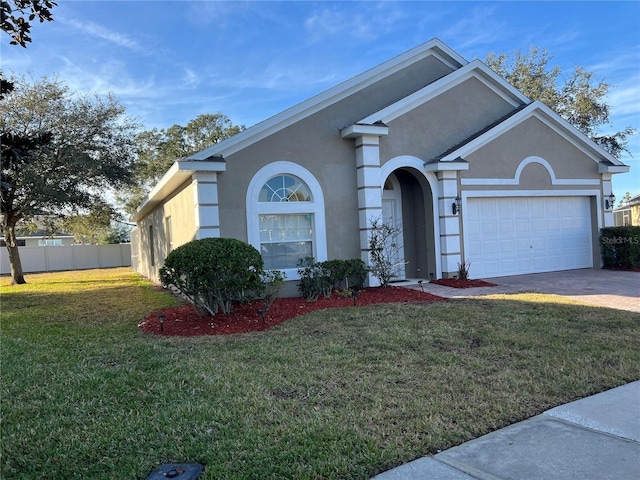 view of front of home featuring a front yard and a garage