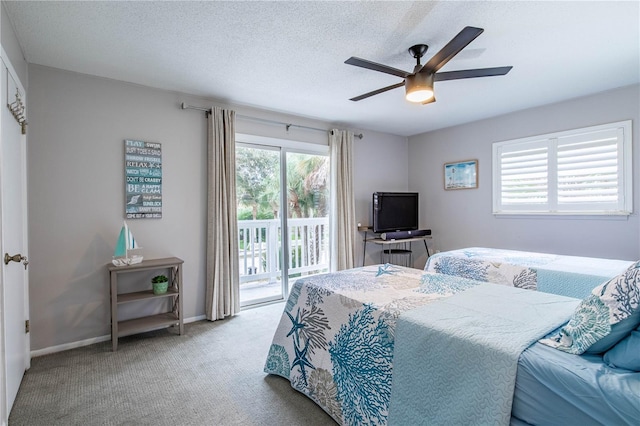 carpeted bedroom with ceiling fan, access to exterior, and a textured ceiling