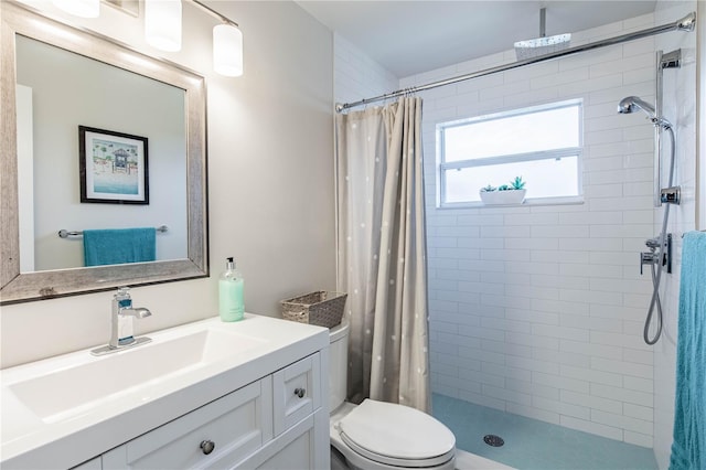 bathroom with curtained shower, vanity, and toilet