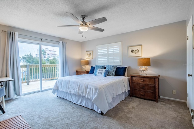 bedroom featuring access to exterior, ceiling fan, light colored carpet, and a textured ceiling