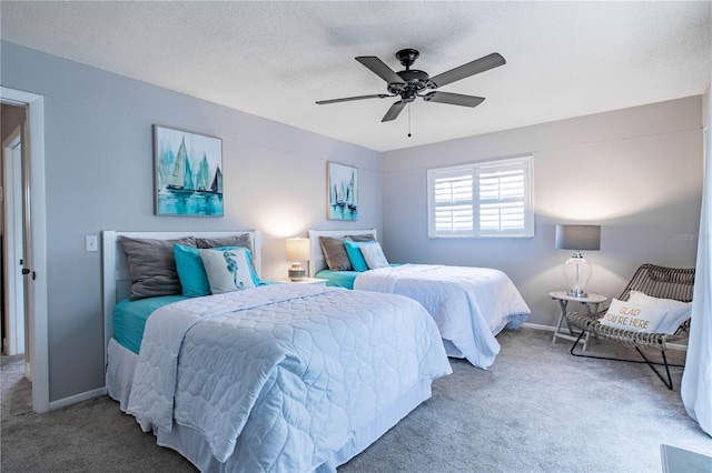 bedroom featuring carpet flooring, ceiling fan, and a textured ceiling