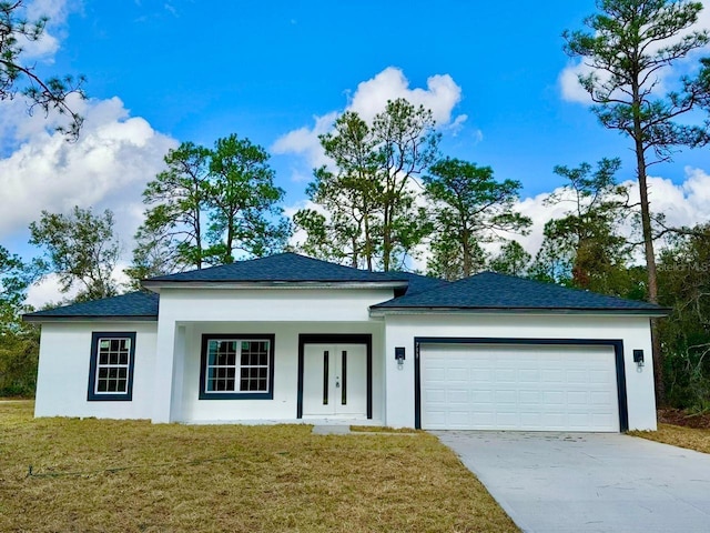 view of front of house with a front yard and a garage