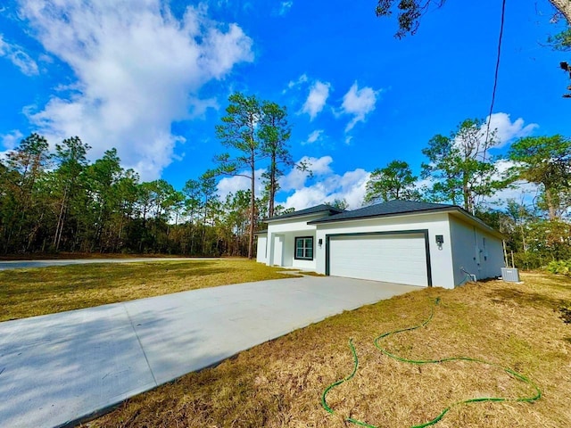 exterior space featuring a front lawn and a garage