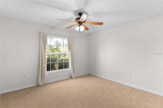 unfurnished room featuring light carpet, ceiling fan, and a textured ceiling