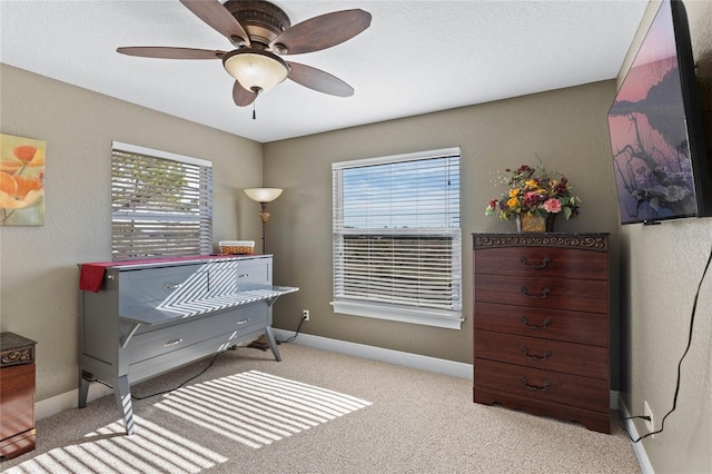 misc room with ceiling fan and light carpet